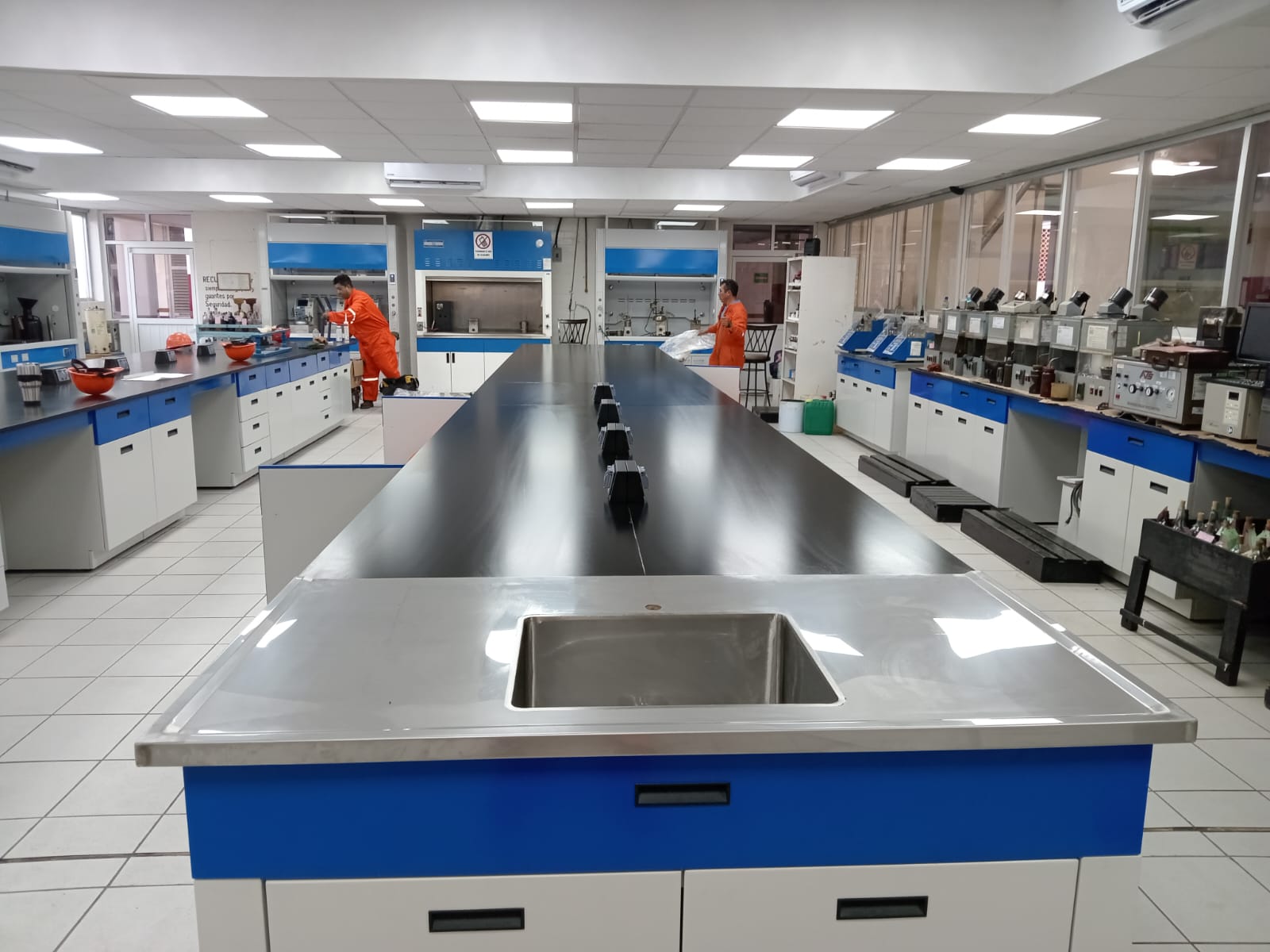 Laboratorio Pemex: línea de bancos con servicios y campanas de extracción